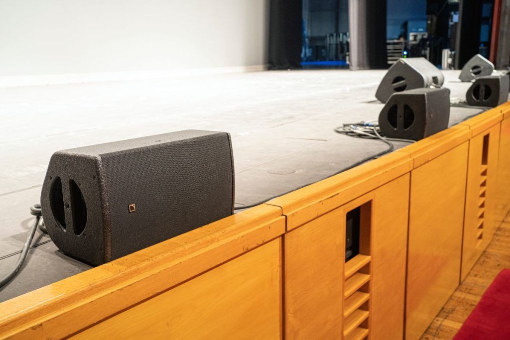 L-Acoustics 5XT spread across the stage lip deliver spatial front-fill in the L-ISA immersive audio configuration