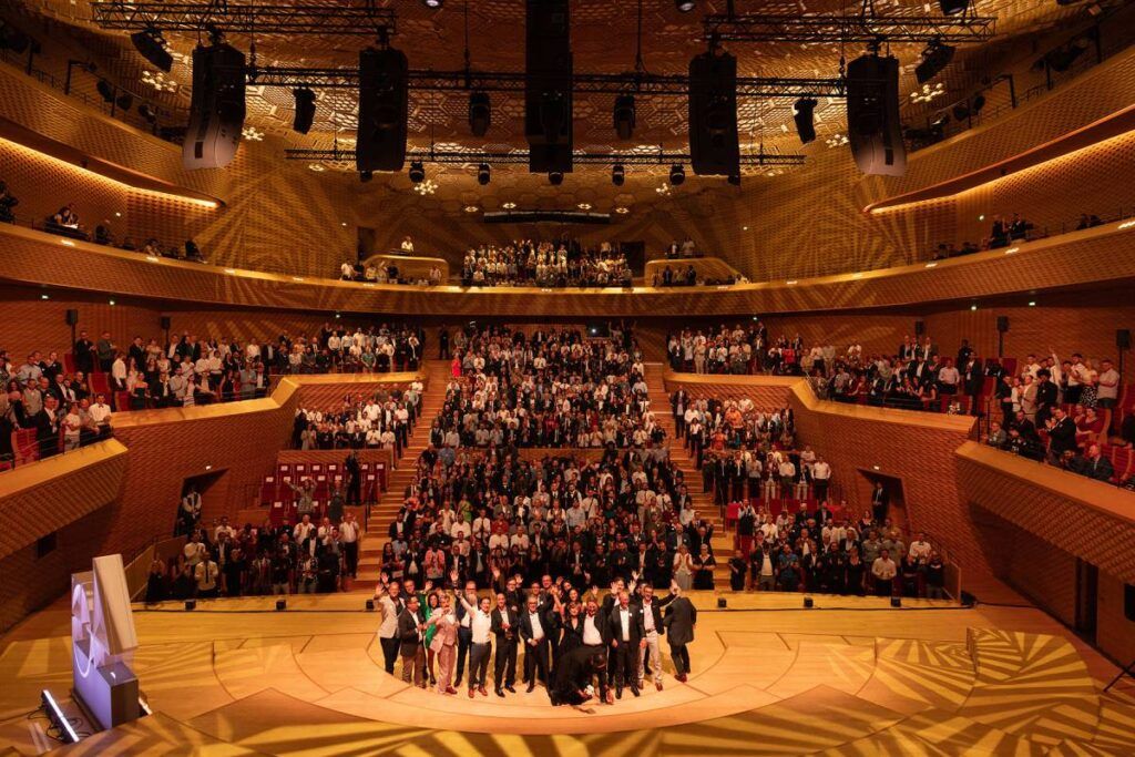 The entire L-Acoustics team celebrating the company’s 40th anniversary at Paris’ La Seine Musicale