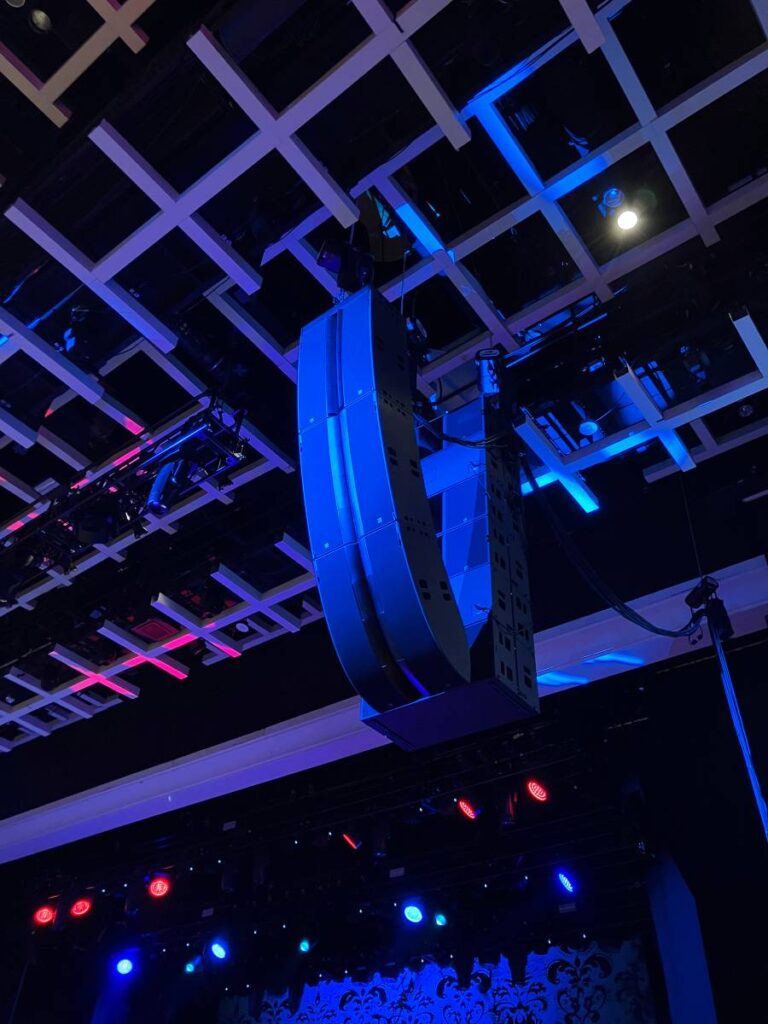 Two L-Acoustics L2 enclosures are flown over one L2D per side, with six KS28 subs hung in a cardioid configuration behind each main array