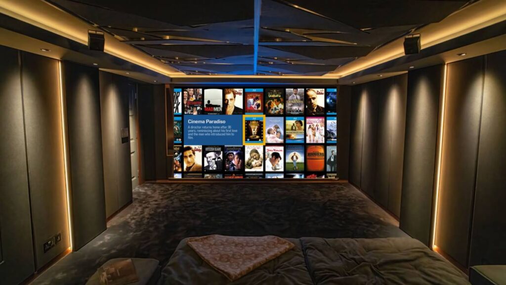 L-Acoustics Soka speakers integrated into custom fabric wall design around preserved sash windows in this Westminster home cinema. 