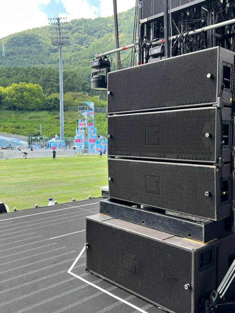 L-Acoustics SB28 subwoofers hidden beneath staging maintained low-end response while allowing for water-play of PSY’s Summer Swag 2025