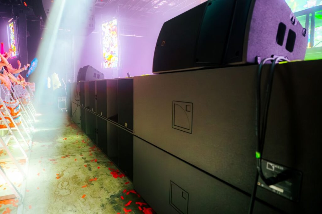 Powerful L-Acoustics KS28 subs line the face of the stage